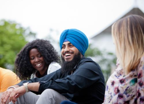 3 Students Sitting and Laughing